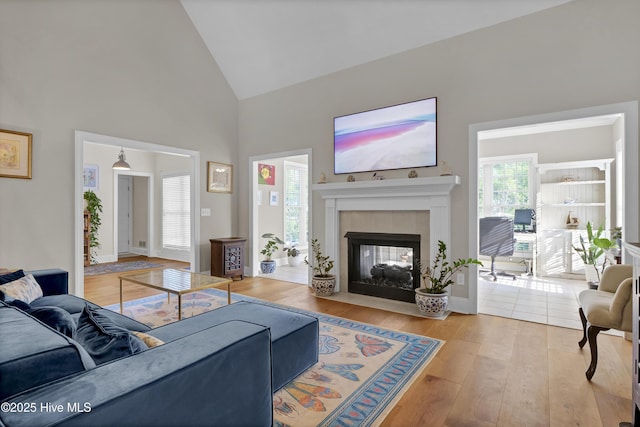 2122 Airlie Brook Dr, Wilmington, NC 28403 - living area featuring hardwood / wood-style floors, high vaulted ceiling, and a tiled fireplace