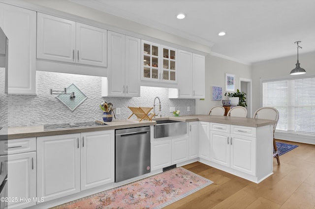 2122 Airlie Brook Dr, Wilmington, NC 28403 - kitchen featuring dishwasher, a peninsula, crown molding, black electric cooktop, and glass insert cabinets