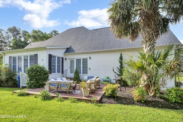 2122 Airlie Brook Dr, Wilmington, NC 28403 - rear view of property featuring an outdoor hangout area, a lawn, brick siding, and a shingled roof