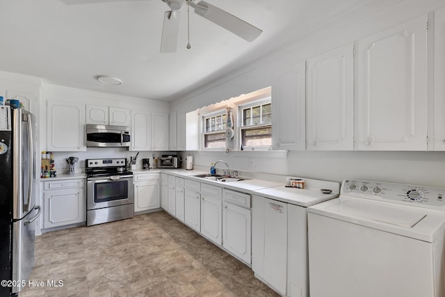 601 Mary Ann Dr, Hampstead, NC 28443 - kitchen featuring washer / dryer, stainless steel appliances, a sink, and white cabinetry