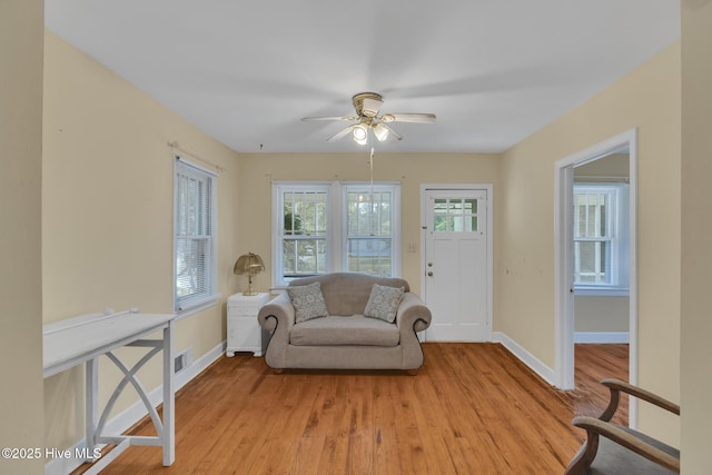 601 Mary Ann Dr, Hampstead, NC 28443 - living area featuring light wood-style floors, baseboards, and a ceiling fan