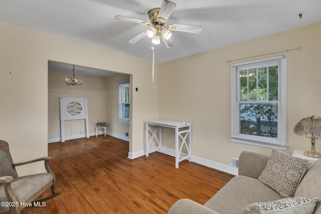 601 Mary Ann Dr, Hampstead, NC 28443 - living room featuring wood finished floors, baseboards, ceiling fan, and a chandelier