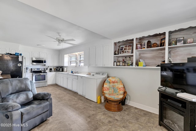 601 Mary Ann Dr, Hampstead, NC 28443 - kitchen with appliances with stainless steel finishes, washer / clothes dryer, a sink, and white cabinets