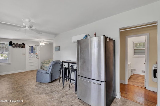 601 Mary Ann Dr, Hampstead, NC 28443 - kitchen with freestanding refrigerator, a ceiling fan, heating unit, and baseboards