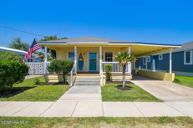 208 Hamlet Ave, Carolina Beach, NC 28428 - bungalow-style home featuring concrete driveway, an attached carport, a porch, and roof with shingles