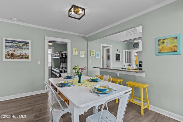 208 Hamlet Ave, Carolina Beach, NC 28428 - dining area featuring dark wood-style floors, baseboards, ornamental molding, and a ceiling fan