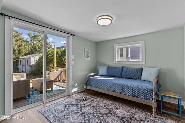 208 Hamlet Ave, Carolina Beach, NC 28428 - bedroom with access to outside, wood finished floors, and baseboards