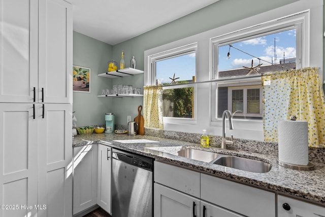 208 Hamlet Ave, Carolina Beach, NC 28428 - kitchen with stainless steel dishwasher, a sink, light stone countertops, and white cabinets