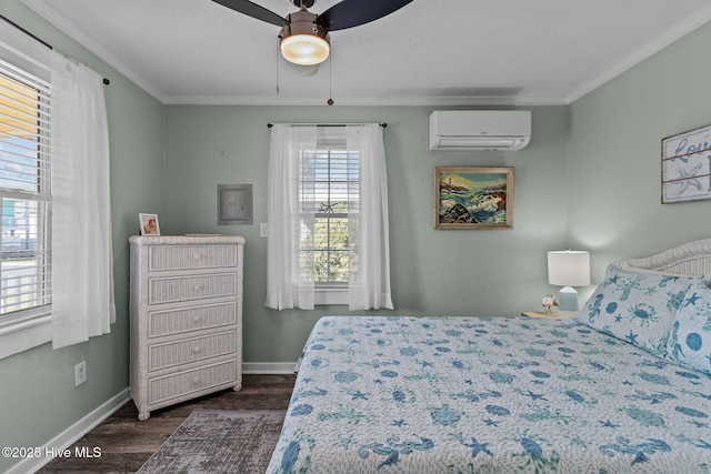 208 Hamlet Ave, Carolina Beach, NC 28428 - bedroom with a wall mounted AC, dark wood-type flooring, baseboards, ornamental molding, and a ceiling fan