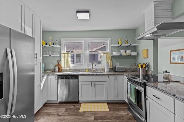 208 Hamlet Ave, Carolina Beach, NC 28428 - kitchen featuring appliances with stainless steel finishes, open shelves, a sink, and wall chimney range hood