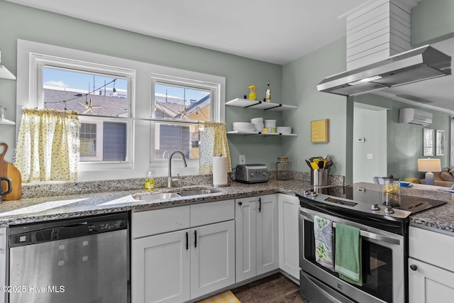 208 Hamlet Ave, Carolina Beach, NC 28428 - kitchen featuring stainless steel appliances, a sink, a wall unit AC, open shelves, and light stone counters