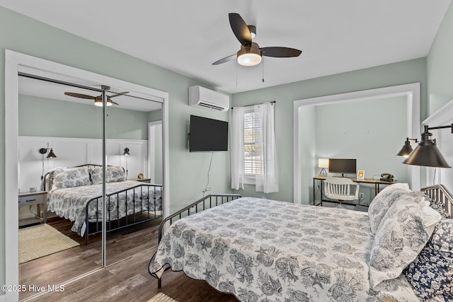 208 Hamlet Ave, Carolina Beach, NC 28428 - bedroom featuring an AC wall unit, wood finished floors, ceiling fan, and a closet