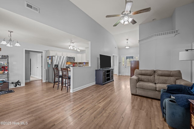 2902 Brems Battery, New Bern, NC 28562 - living area featuring light wood-style flooring, a ceiling fan, high vaulted ceiling, and a chandelier