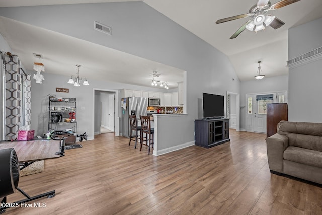 2902 Brems Battery, New Bern, NC 28562 - living area featuring high vaulted ceiling, light wood finished floors, a ceiling fan, and a chandelier
