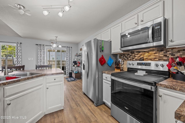 2902 Brems Battery, New Bern, NC 28562 - kitchen with stainless steel appliances, white cabinetry, light wood-style flooring, tasteful backsplash, and dark countertops