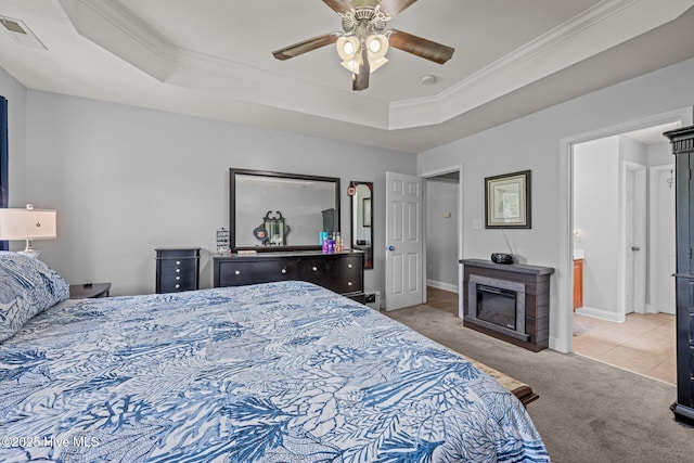 2902 Brems Battery, New Bern, NC 28562 - bedroom with carpet, a tray ceiling, ornamental molding, a glass covered fireplace, and ceiling fan