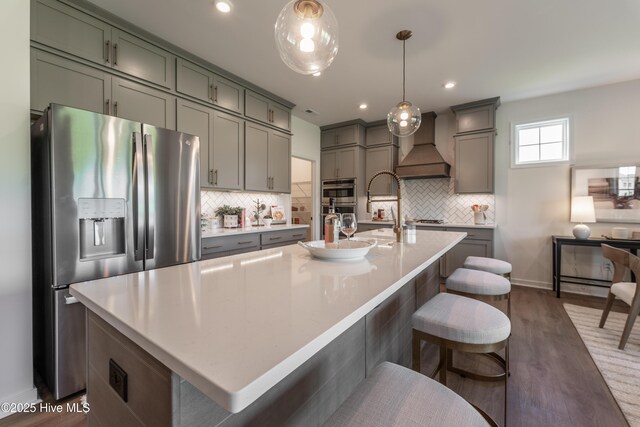 1016 Fawn Valley Way, Wilmington, NC 28409 - kitchen with stainless steel appliances, custom range hood, gray cabinets, dark wood finished floors, and recessed lighting