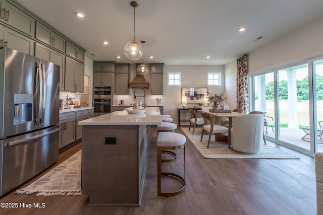 1016 Fawn Valley Way, Wilmington, NC 28409 - kitchen featuring appliances with stainless steel finishes, gray cabinetry, light countertops, dark wood-type flooring, and tasteful backsplash