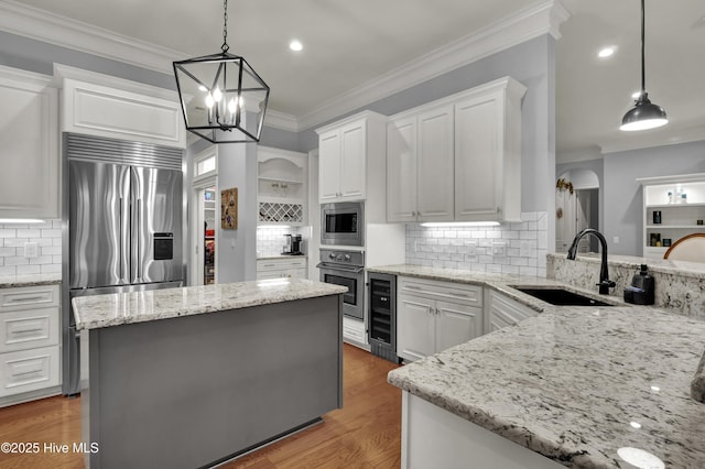 3807 Ridge Crest Dr, Southport, NC 28461 - kitchen with stainless steel appliances, a sink, wine cooler, tasteful backsplash, and white cabinetry