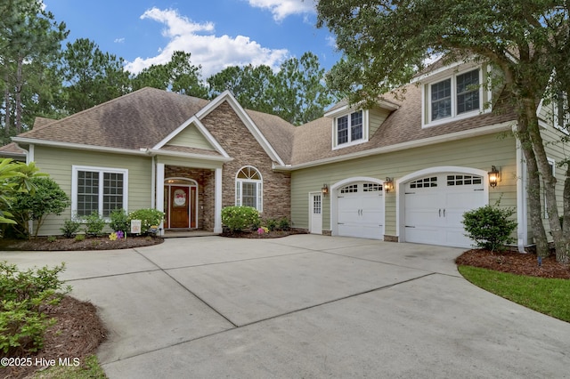 3807 Ridge Crest Dr, Southport, NC 28461 - view of front of property with driveway, roof with shingles, and stone siding
