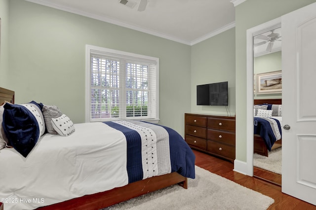 3807 Ridge Crest Dr, Southport, NC 28461 - bedroom with crown molding, wood finished floors, and a ceiling fan