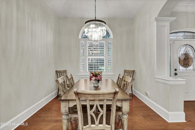 3807 Ridge Crest Dr, Southport, NC 28461 - dining space with a chandelier, baseboards, and wood finished floors