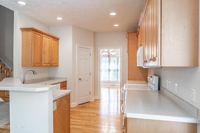 114 Baker Cir W, End, NC 27376 - kitchen featuring white appliances, recessed lighting, light wood-style flooring, a peninsula, and light countertops