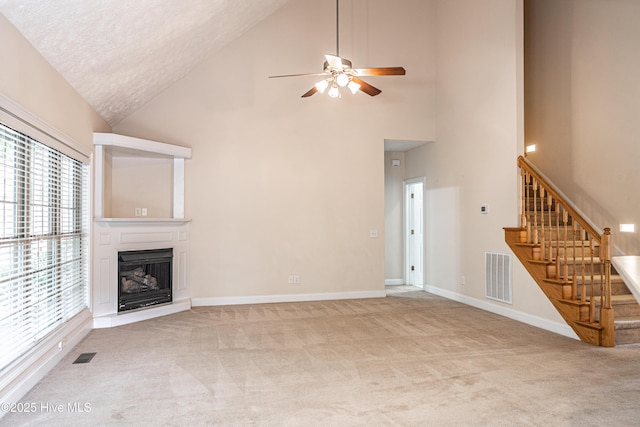 114 Baker Cir W, End, NC 27376 - unfurnished living room featuring high vaulted ceiling, stairs, light carpet, ceiling fan, and a fireplace