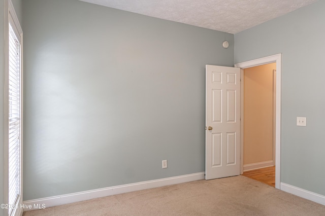 114 Baker Cir W, End, NC 27376 - empty room with carpet, baseboards, and a textured ceiling