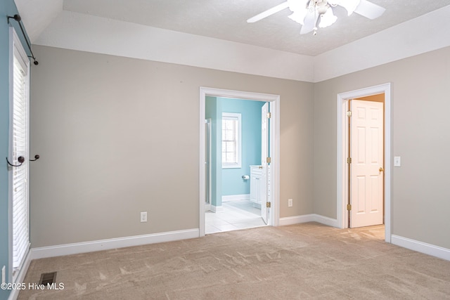 114 Baker Cir W, End, NC 27376 - unfurnished bedroom featuring light carpet, baseboards, ensuite bathroom, and lofted ceiling