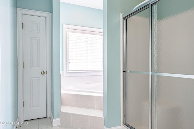 114 Baker Cir W, End, NC 27376 - bathroom featuring a bath, tile patterned floors, a shower stall, and baseboards