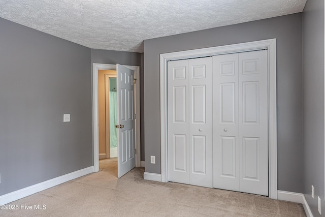 114 Baker Cir W, End, NC 27376 - unfurnished bedroom featuring carpet, a closet, baseboards, and a textured ceiling