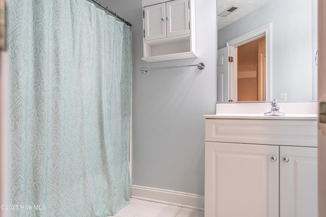 114 Baker Cir W, End, NC 27376 - bathroom featuring tile patterned floors, vanity, and baseboards