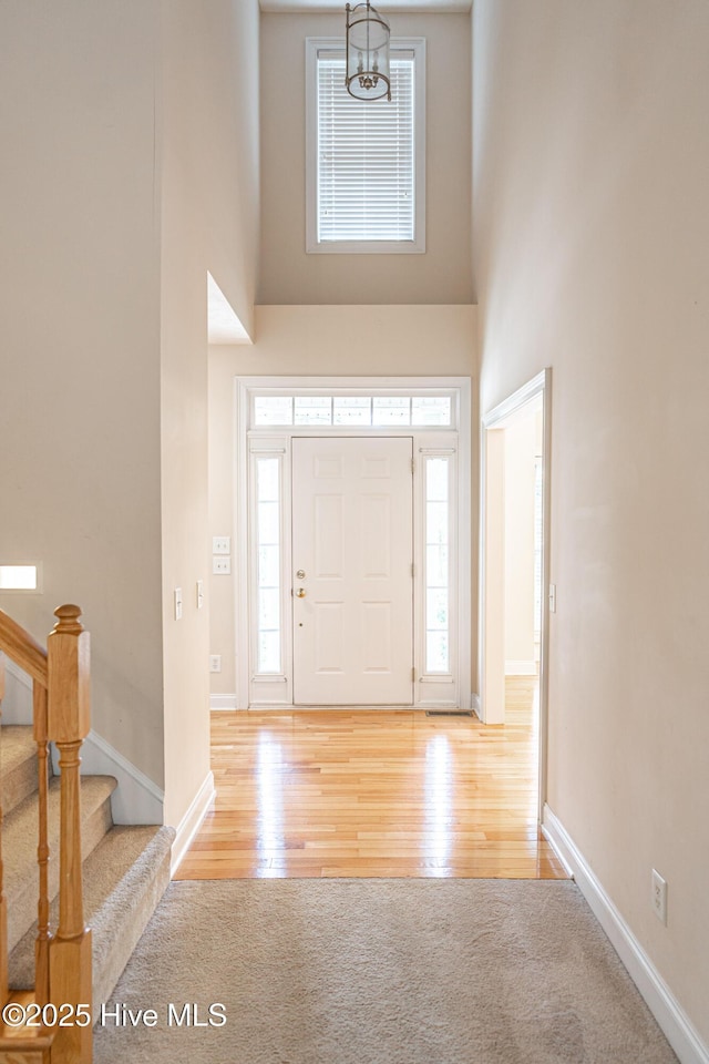 114 Baker Cir W, End, NC 27376 - entrance foyer with a high ceiling, baseboards, wood finished floors, and stairs