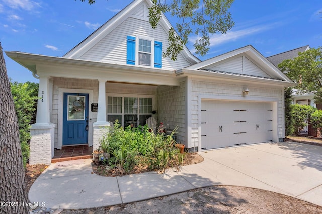 414 Wilson Ave, Carolina Beach, NC 28428 - view of front of property featuring a porch, driveway, and a garage