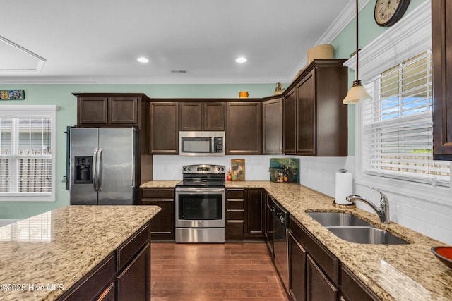 414 Wilson Ave, Carolina Beach, NC 28428 - kitchen with stainless steel appliances, plenty of natural light, dark brown cabinetry, dark wood-style flooring, and crown molding