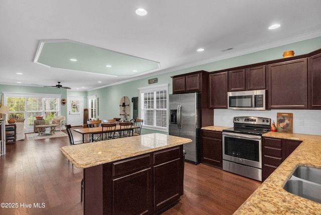 414 Wilson Ave, Carolina Beach, NC 28428 - kitchen featuring stainless steel appliances, dark brown cabinets, light stone counters, recessed lighting, and dark wood-style floors