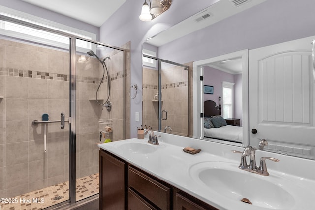 414 Wilson Ave, Carolina Beach, NC 28428 - ensuite bathroom with plenty of natural light, a shower stall, and double vanity