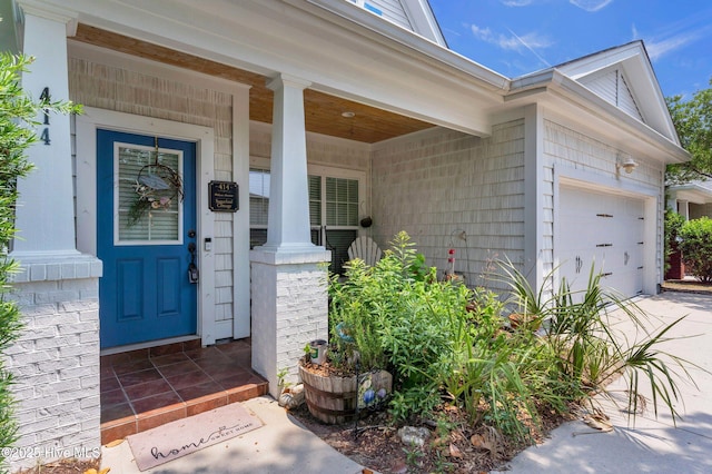 414 Wilson Ave, Carolina Beach, NC 28428 - entrance to property featuring a garage, driveway, and a porch