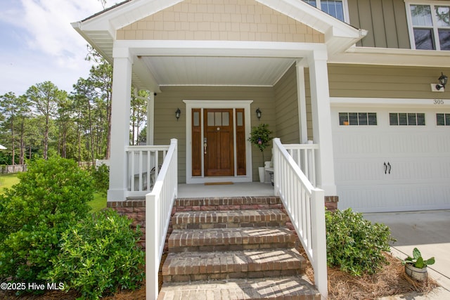 305 3rd St, Aberdeen, NC 28315 - doorway to property featuring board and batten siding, a porch, and concrete driveway