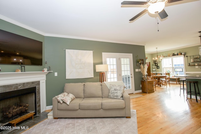 305 3rd St, Aberdeen, NC 28315 - living area featuring ornamental molding, a ceiling fan, a chandelier, a tiled fireplace, and baseboards