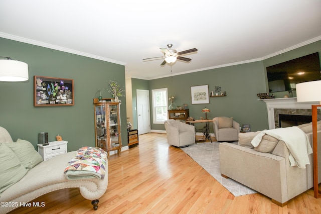 305 3rd St, Aberdeen, NC 28315 - living room with ornamental molding, ceiling fan, wood finished floors, a tile fireplace, and baseboards