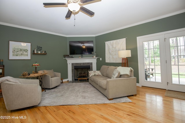 305 3rd St, Aberdeen, NC 28315 - living room featuring crown molding, wood finished floors, a ceiling fan, a fireplace, and baseboards