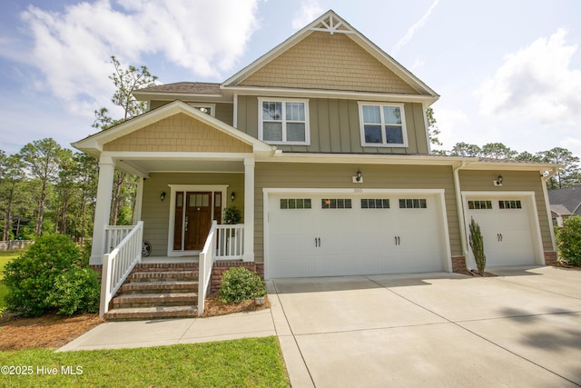 305 3rd St, Aberdeen, NC 28315 - craftsman-style home featuring concrete driveway, board and batten siding, an attached garage, and covered porch