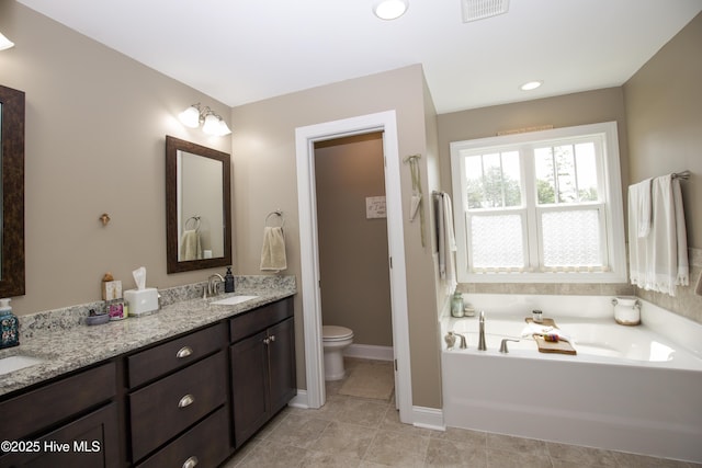 305 3rd St, Aberdeen, NC 28315 - bathroom featuring double vanity, a bath, toilet, baseboards, and tile patterned flooring