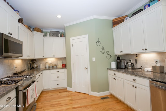 305 3rd St, Aberdeen, NC 28315 - kitchen featuring stainless steel appliances, tasteful backsplash, ornamental molding, white cabinetry, and light wood-style flooring