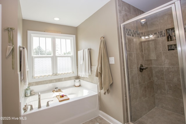305 3rd St, Aberdeen, NC 28315 - bathroom with a garden tub, a stall shower, tile patterned flooring, and baseboards