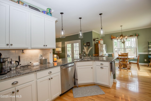 305 3rd St, Aberdeen, NC 28315 - kitchen featuring stainless steel dishwasher, a sink, light wood finished floors, backsplash, and a peninsula