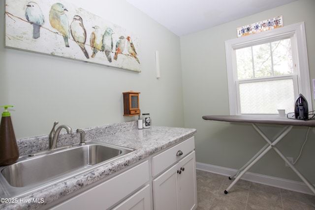 305 3rd St, Aberdeen, NC 28315 - laundry area featuring a sink, baseboards, and tile patterned flooring