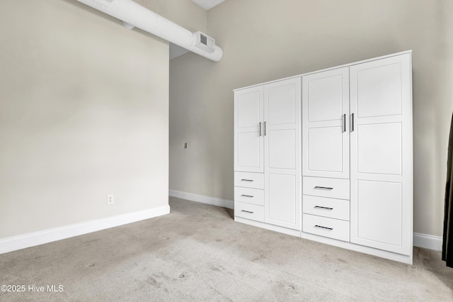 2906 Market St Unit 301, Wilmington, NC 28403 - unfurnished bedroom featuring light colored carpet, baseboards, and a closet